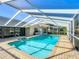 The pool features clear blue water, a screened enclosure, and brick pavers at 560 Saint Andrews Rd, Winter Haven, FL 33884