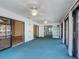 The sunroom features sliding doors, an exterior view of the pool, and ceiling fans at 560 Saint Andrews Rd, Winter Haven, FL 33884
