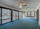 The sunroom features an exterior view of the pool, multiple ceiling fans, and large sliding doors at 560 Saint Andrews Rd, Winter Haven, FL 33884