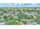 An elevated view of a residential neighborhood with tree-lined streets, houses with driveways, and vibrant green spaces at 616 Oriole Dr, Lakeland, FL 33803