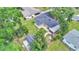 Aerial view of the home with large yard, mature trees, patio, and detached shed at 616 Oriole Dr, Lakeland, FL 33803
