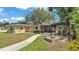 Backyard showing a fire pit and swing set with the house and screened-in porch in the background at 616 Oriole Dr, Lakeland, FL 33803