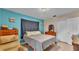 Bright bedroom boasts blue accent walls, a closet, and a serene ambiance at 616 Oriole Dr, Lakeland, FL 33803