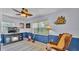 Comfortable bonus room with a fireplace, nautical accents, and a ceiling fan at 616 Oriole Dr, Lakeland, FL 33803