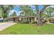 Charming single-story home with mature trees, well-kept lawn, and convenient covered parking at 616 Oriole Dr, Lakeland, FL 33803