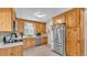 Bright kitchen with stainless steel appliances, custom cabinets, and mosaic tile backsplash at 616 Oriole Dr, Lakeland, FL 33803
