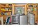 Laundry room with modern washer, dryer, water heater, and storage shelves at 616 Oriole Dr, Lakeland, FL 33803