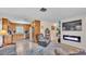 Inviting living room features a fireplace, tile floors, and an open flow into the kitchen at 616 Oriole Dr, Lakeland, FL 33803