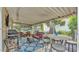 Spacious enclosed patio featuring a dining table, grill, and comfortable outdoor seating at 616 Oriole Dr, Lakeland, FL 33803