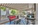 Enclosed patio featuring outdoor furniture, grill, blue printed rug, and string lights at 616 Oriole Dr, Lakeland, FL 33803