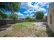 Spacious backyard featuring a wood fence providing privacy, and scattered trees offering shade at 630 Heather Glen Loop, Winter Haven, FL 33884