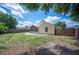 Large backyard with a screened porch area, wooden fence, and a gate providing easy access at 630 Heather Glen Loop, Winter Haven, FL 33884