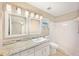 This bathroom features a shower, and dual mirrors above granite countertops at 630 Heather Glen Loop, Winter Haven, FL 33884