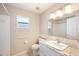The bathroom features granite countertops, a white vanity, and a walk-in shower at 630 Heather Glen Loop, Winter Haven, FL 33884