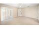 This bedroom features carpet, a ceiling fan, and a sliding glass door at 630 Heather Glen Loop, Winter Haven, FL 33884