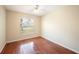 This bedroom features a ceiling fan, a window, and hardwood flooring at 630 Heather Glen Loop, Winter Haven, FL 33884
