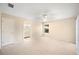 This bedroom features a ceiling fan, carpet, and an attached bathroom at 630 Heather Glen Loop, Winter Haven, FL 33884