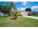 Well-maintained one-story home with green lawn, a two-car garage, and mature palm trees at 630 Heather Glen Loop, Winter Haven, FL 33884