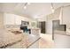 Updated kitchen boasts granite countertops, stainless appliances and white cabinetry at 630 Heather Glen Loop, Winter Haven, FL 33884