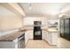 Bright kitchen featuring granite countertops, stainless appliances, and stylish white cabinets at 630 Heather Glen Loop, Winter Haven, FL 33884