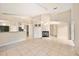 Bright living room featuring tile flooring, a fireplace and open access to the kitchen at 630 Heather Glen Loop, Winter Haven, FL 33884