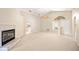 Open-concept living area with a cozy fireplace, high ceilings, and plenty of natural light at 630 Heather Glen Loop, Winter Haven, FL 33884