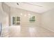 Living room showcasing tile floors, three pendant lights and sliding door access to the porch at 630 Heather Glen Loop, Winter Haven, FL 33884