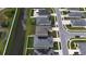 An aerial shot of a community with waterfront views and homes equipped with solar panels for energy efficiency at 648 Lorient Dr, Eagle Lake, FL 33839