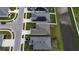 An aerial view of the rooftops of homes with Solar Panels located along a canal at 648 Lorient Dr, Eagle Lake, FL 33839