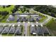 An aerial view shows houses bordering a retention pond in a residential community at 648 Lorient Dr, Eagle Lake, FL 33839