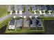 This aerial view of houses shows its location surrounded by streets and ponds at 648 Lorient Dr, Eagle Lake, FL 33839