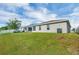 Exterior home photo with a well-manicured lawn and a screen enclosed lanai at 648 Lorient Dr, Eagle Lake, FL 33839