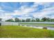 Spacious backyard featuring a well-maintained lawn and a serene water view at 648 Lorient Dr, Eagle Lake, FL 33839