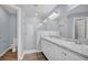 Bathroom with dual vanity, glass enclosed shower, and wood look floors at 648 Lorient Dr, Eagle Lake, FL 33839