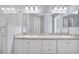 Bathroom boasts dual sinks, a large mirror and glass shower at 648 Lorient Dr, Eagle Lake, FL 33839