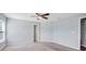 Spacious carpeted bedroom has a ceiling fan and closet at 648 Lorient Dr, Eagle Lake, FL 33839