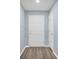 Clean and bright entryway with wood-look flooring and white doors at 648 Lorient Dr, Eagle Lake, FL 33839
