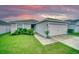 Charming single-story home with a well-manicured lawn and attached two-car garage at 648 Lorient Dr, Eagle Lake, FL 33839