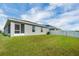 The home's rear exterior shows a screened lanai and a well-manicured lawn at 648 Lorient Dr, Eagle Lake, FL 33839