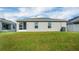 The home's exterior shows a screened lanai and a well-manicured lawn at 648 Lorient Dr, Eagle Lake, FL 33839