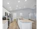 Bright kitchen with white cabinets, stainless appliances, and long island at 648 Lorient Dr, Eagle Lake, FL 33839