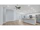 Bright living room with vaulted ceilings, fan, and views into the kitchen at 648 Lorient Dr, Eagle Lake, FL 33839