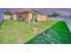 A spacious backyard with a patio area, lush green grass, and a white fence for privacy at 713 Overlook Grove Dr, Winter Haven, FL 33884