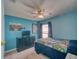 Bright bedroom featuring a ceiling fan, dark dresser, and natural light from the window at 713 Overlook Grove Dr, Winter Haven, FL 33884