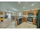 Inviting kitchen featuring wooden cabinets and stainless steel appliances open to the dining and living space at 713 Overlook Grove Dr, Winter Haven, FL 33884