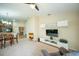 Open-concept living room featuring a ceiling fan, wall decorations, and direct access to the kitchen at 713 Overlook Grove Dr, Winter Haven, FL 33884