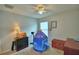 Bedroom features a ceiling fan, a play tent, and a traditional wooden chest at 879 Orleans Dr, Eagle Lake, FL 33839