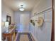 Cozy foyer with decorative wall accents, wooden floors, and a stylish accent table at 879 Orleans Dr, Eagle Lake, FL 33839