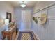 Welcoming entryway features a charming hall table and decorative wall hooks for a stylish and functional space at 879 Orleans Dr, Eagle Lake, FL 33839