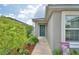 Beautiful house with a blue front door, flower wreath, and manicured landscaping at 879 Orleans Dr, Eagle Lake, FL 33839